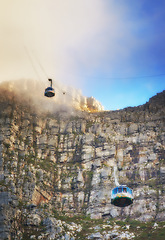 Image showing Nature, clouds and blue sky with aerial cable car on Table Mountain for outdoor adventure, travel destination and sightseeing. Low angle, national landmark and tourism for peace, calm and relax.