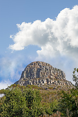 Image showing Mountain, peak and natural landscape with cloudy sky, summer and serene hill with forest trees. Nature, tranquil cliff and sustainable environment with earth, travel and calm volcano on island