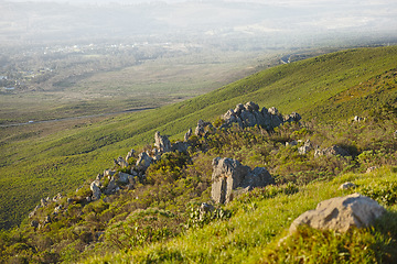 Image showing Mountain, fog and natural landscape with grass, rocks and calm field for travel location. Nature, hill and sustainable environment with earth, peace and holiday destination with planet conservation