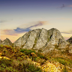 Image showing Mountains, environment and countryside with nature, clouds and stone with landscape and weekend break. Empty, rock and grass with flowers or springtime with summer and travel with adventure or growth