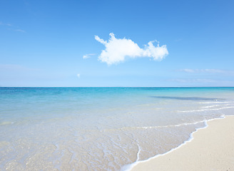 Image showing Ocean, Bahamas and blue sky for holiday, sand and rocks in shore for peace and tranquility. Seaside, waves and summer for vacation, location and beach for clear water on travel and tropical trip