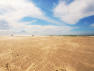 Image showing Sand, beach and blue sky with clouds in nature for travel, vacation or holiday in Cape town. Landscape, ocean and water by seashore on tropical island for scenic outdoor summer weekend trip.