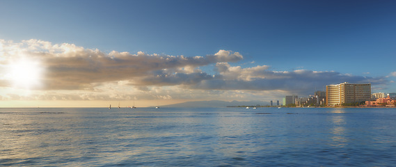 Image showing Blue sky, ocean and clouds with city background for peace, nature and environment with skyline seascape of tropical beach. Calm water, sea and horizon with location for break or vacation with view