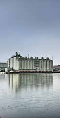 Image showing Factory, sky, and water for warehouse and manufacturing in building for industry and development. Production, plant and resources for logistics and storage in container for distribution on rig