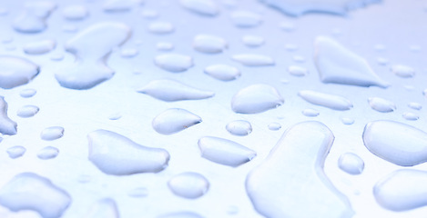 Image showing Closeup, water and droplets on metal surface, winter and rain in cold season. Hydration, natural splash of clean sustainability from weather, refreshing and clear liquid for texture, refresh and wash