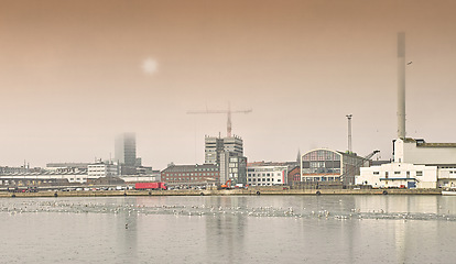 Image showing Harbor, industrial buildings and town in outdoors, treatment plant and development by factory. Production, warehouse and power station or refinery in Aarhaus, Denmark and river or lake outside