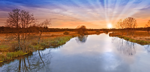 Image showing River, farm and sunset or nature landscape in summer environment in England countryside, travel or horizon. Water, agriculture and panorama of filed meadow or clean energy or dusk sky, growth or lawn