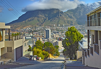 Image showing Neighborhood, city and buildings with travel and street, architecture and skyscraper with landscape. Property, real estate and urban development, location with residential area and background