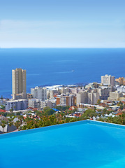 Image showing Pool, city building and ocean outdoor for travel destination in summer for hotel swimming, infrastructure or downtown. Skyline, water and lodge accommodation in Cape Town or relax, trip or vacation