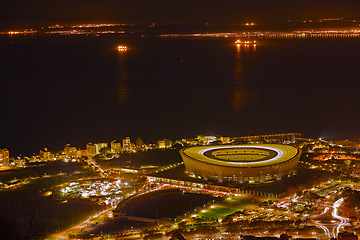 Image showing Night, city and top view with travel and lights, architecture and skyscraper with outdoor landscape. Property, real estate and urban development, destination or location with skyline and background