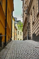 Image showing Travel, stone and alley in vintage town with history, culture or holiday destination in Sweden. Vacation, old buildings and antique street in Stockholm with cobble road architecture in ancient city.