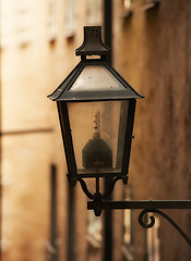 Image showing Travel, architecture and lamp on retro building in old town with history, culture or holiday destination in Sweden. Vacation, landmark and antique lantern in Stockholm with vintage light ancient city