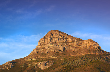 Image showing Mountain, peak and natural landscape with blue sky, summer and calm cliff at tranquil travel location. Nature, evening and sustainable environment with earth, sunshine and serene hill in Cape Town