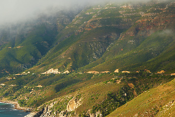 Image showing Mountain, fog and natural landscape with green beach, calm hill and clouds at travel location. Nature, ecology and sustainable environment with earth, ocean and holiday destination with conservation