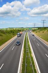 Image showing Highway, road and cars with landscape for travel with clouds, blue sky and environment in Denmark. Aerial, motor and transportation with skyline, driving and street in countryside for journey or trip