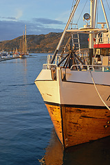 Image showing Ship, water and harbor at sea to coast guard with landscape, blue sky and transportation for emergency sailing. Vessel, dock and ocean with safety for maritime, danger or patrol in morning and nature