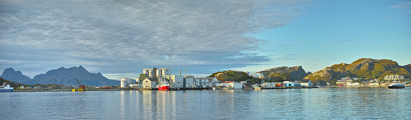 Image showing Industrial, landscape and factory by the ocean for manufacturing, plant or mill with boat outdoor. Panoramic view, nautical vessel for production in industry, marina or dock with natural background