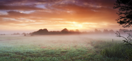 Image showing Landscape, clouds and drone in nature, sunset or peace in morning with countryside tranquility. Freedom, aerial view and sunrise outdoor for travel, explore or adventure, vacation or Amsterdam trip