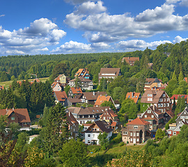 Image showing Houses, village or countryside landscape, travel and adventure location with trees in nature and buildings outdoor. Neighborhood, real estate and property with architecture for holiday in Germany