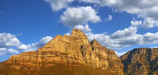 Image showing Mountain, blue sky and sunset with natural landscape for travel location, outdoor adventure and environment. Banner, nature and clouds for peace, explore and holiday destination in Cape Town.