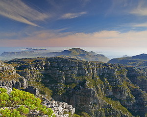 Image showing Mountain, clouds and natural landscape with sky, sea and calm cliff at travel location. Nature, island peak and sustainable environment with earth, ocean and tropical holiday destination with fog