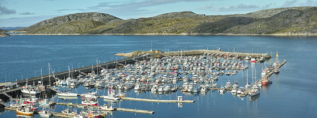 Image showing Harbor, ship and marina in nature outdoors, travel and yacht on holiday or vacation and sail. Port, mountain and boat on water for peace or calm at dock, cruise transport and ocean or sea on island
