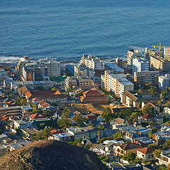 Image showing City, building and sea or aerial with development infrastructure or summer holiday, explore or downtown. Water, urban and ocean or mountain in South Africa for traveling vacation, residential or trip