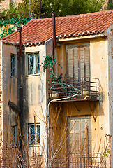 Image showing Village, architecture and abandoned house with balcony in Athens for heritage, culture and tradition. Building, property and ancient residential community or neighborhood in ghost town and historic