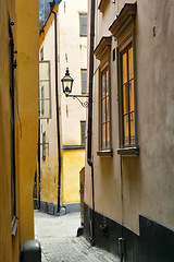 Image showing Travel, buildings and alley in ancient town with history, culture or holiday destination in Sweden. Vacation, old architecture and antique stone street in Stockholm with cobble path in vintage city