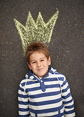 Image showing Chalk art, portrait and boy with crown on floor for drawing, imagine or future fantasy on black background. King, face or boy with sketch of royalty, prince or dream for school, project or assignment