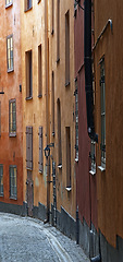 Image showing Travel, architecture and street with vintage buildings in old town with history, culture or holiday destination in Sweden. Vacation, alley and antique road in Stockholm with apartment in ancient city