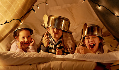 Image showing Tent, games and portrait of children at night in bedroom for playing and bonding together. Home, youth and happy kids with spoon, helmet pots and blanket fort for playful, imaginary and childhood fun