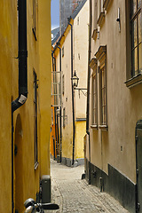 Image showing Travel, architecture and alley in ancient town with history, culture or holiday destination in Sweden. Vacation, old buildings and antique stone street in Stockholm with cobble path in vintage city