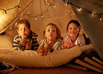 Image showing Children, fort and portrait of siblings in a bed with fun, toy and bonding while blowing bubbles at home together. Family, night and kids in a bedroom for evening games, playing or indoor camping