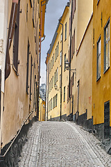 Image showing Travel, architecture and street in vintage alley with history, culture or holiday destination in Sweden. Vacation, old buildings and antique stone road in Stockholm with cobble path in ancient city