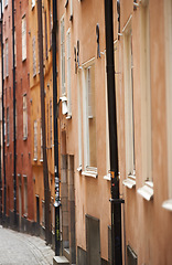 Image showing Travel, buildings and alley in vintage town with history, culture or holiday destination in Sweden. Vacation, old architecture and antique street in Stockholm with retro cobble road in ancient city