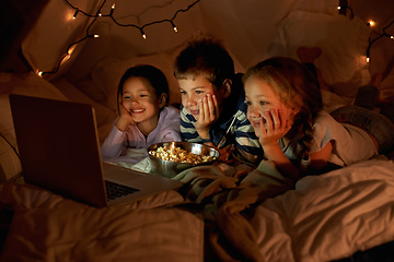 Image showing Children, computer and watch in tent at night with movies, film or cartoons for holiday adventure or vacation. Young boy, girl or kids with lights, pillows and blanket at home on laptop for Netflix