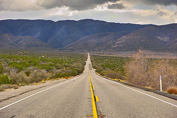 Image showing Mountain, road trip and natural landscape for travel, holiday and scenery at Anza-Borrego Desert State Park in California. Nature, cloudy sky and highway for journey, vacation and outdoor adventure.