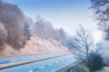Image showing Highway, road trip and natural landscape for travel, holiday and winter trees in countryside. Nature, forest and street for journey, vacation or outdoor adventure with peace, relax and wilderness.