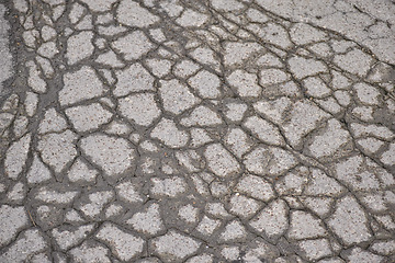 Image showing Water, asphalt and road in countryside with cracks for maintenance, infrastructure and transport in winter. Tar, path and rain in erosion pattern on street with damage, ground and problem with travel