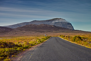 Image showing Mountains, road trip and green landscape with travel, holiday and natural countryside in South Africa. Nature, environment and highway for journey, vacation and outdoor adventure with clouds in sky.