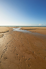 Image showing Beach, sand and water from river, ocean and scenic landscape in natural environment. Fresh water, estuary and lagoon in Denmark, holiday or summer vacation and rural outdoor conservation area