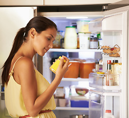 Image showing Fridge, cooking and woman with sauce in kitchen checking nutrition label for preparing meal. Food, ingredients and female person reading information on mustard for dinner, supper or lunch at home.