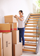 Image showing Woman, new home and moving boxes for property investment, rental apartment or real estate loan. Smile, tenant and female person carrying cardboard package for logistics, relocation or renovation.