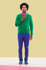 Image showing Fashion, black man and studio with colorful clothes in yellow background for trendy, style and outfit. Male person, stylist and elegant for season trends with funky, formal wear and edgy look.
