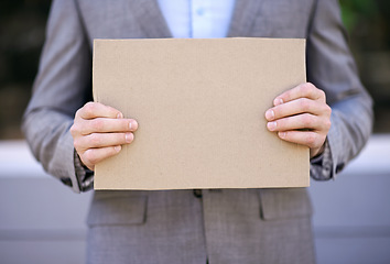 Image showing Unemployment, blank and hands with cardboard, outdoor and adult with poverty as auditor. Person, search and job hunting for work with sign on street in city of Cape Town, career and poster for mockup