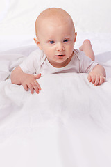 Image showing Bed, blanket and face of baby in studio on a white background for child development, care and growth. Sleep, leisure and isolated newborn rest, relax and nap for childhood, wellness and comfort