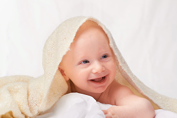 Image showing Baby, laugh or blanket to play, relax or comfort in funny, goofy and nursery on white background. Happy, young child or linen for peaceful rest for health, wellbeing or childhood development