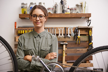 Image showing Mechanic, woman and bicycle with tools and smile at workshop for repair, maintenance with small business. Entrepreneur, garage and expert with diy for bike with equipment for service and upgrade