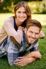 Image showing Couple, park and grass with smile, portrait and love for date and relationship or bonding. Man, woman and nature with romance, new york and sunshine lying together on outdoor adventure or holiday